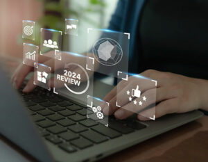 An image of hands on a keyboard, with icons floating in the air 
