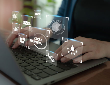 An image of hands on a keyboard, with icons floating in the air