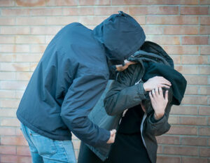 An image of a boy being threatened with violence by another boy