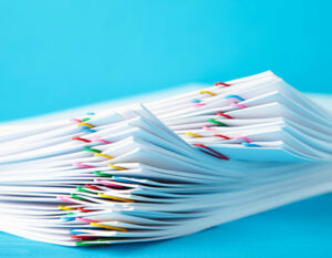 A pile of reports clipped together with paperclips