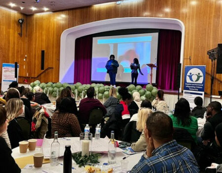 an image of people presenting on stage